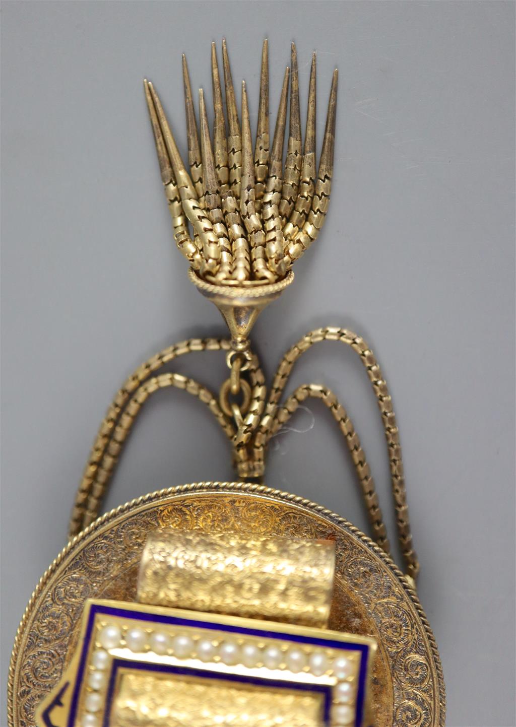 A Victorian gold (tests as 14ct), pearl and blue enamel tassel brooch with central buckle motif and a pair of matching earrings,